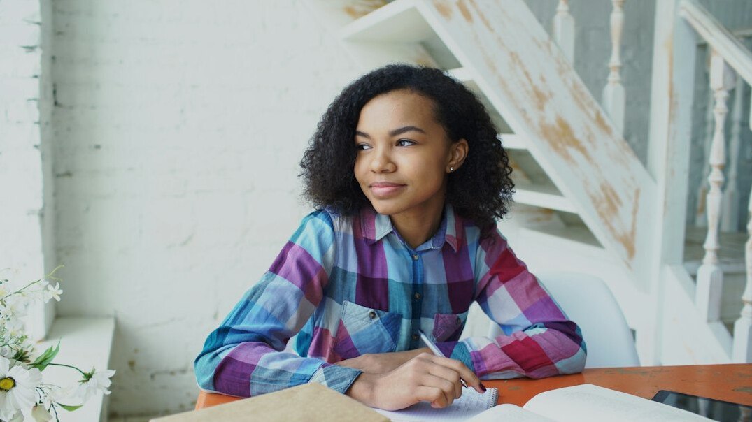 writer at desk with notebook